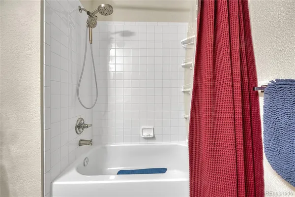 a bathroom with a bath tub and shower