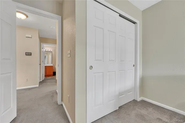 an empty room and a bathroom with a sink