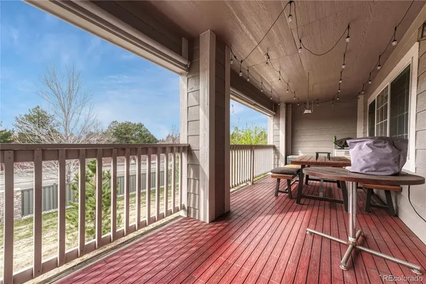 a view of a patio with table and chairs and wooden floor