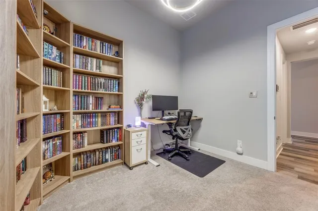 a view of a workspace with bookshelf and a workspace