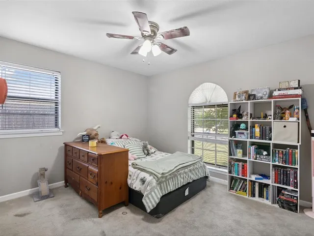 a bedroom with a bed and a book shelf