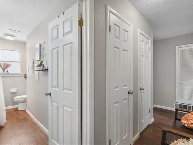 a bathroom with a granite countertop toilet a sink and a mirror