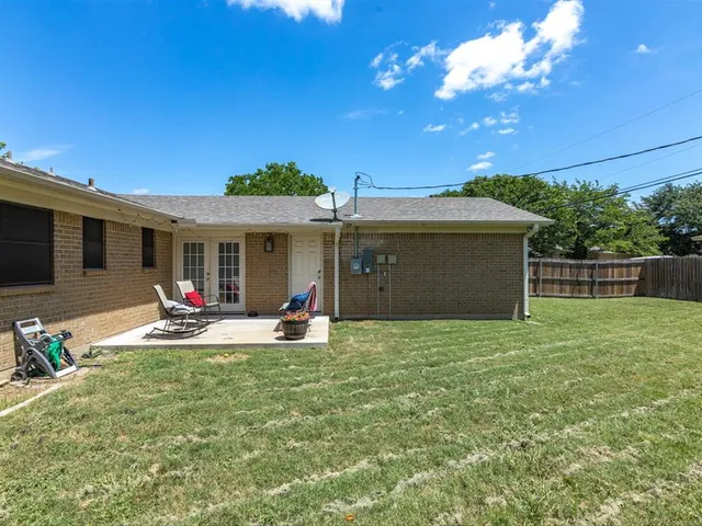 a view of a house with backyard porch and sitting area