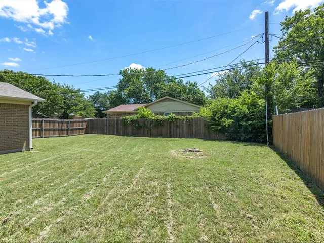 a backyard of a house with lots of green space