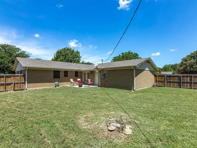 a yellow house in middle of the green field