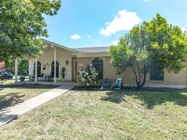 a view of a house with a yard and garage