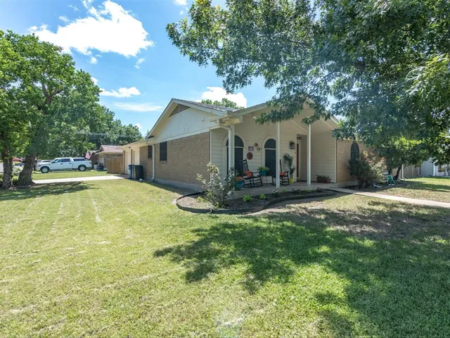 a view of a house with swimming pool next to a yard