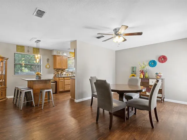 a dining room with furniture a window and wooden floor