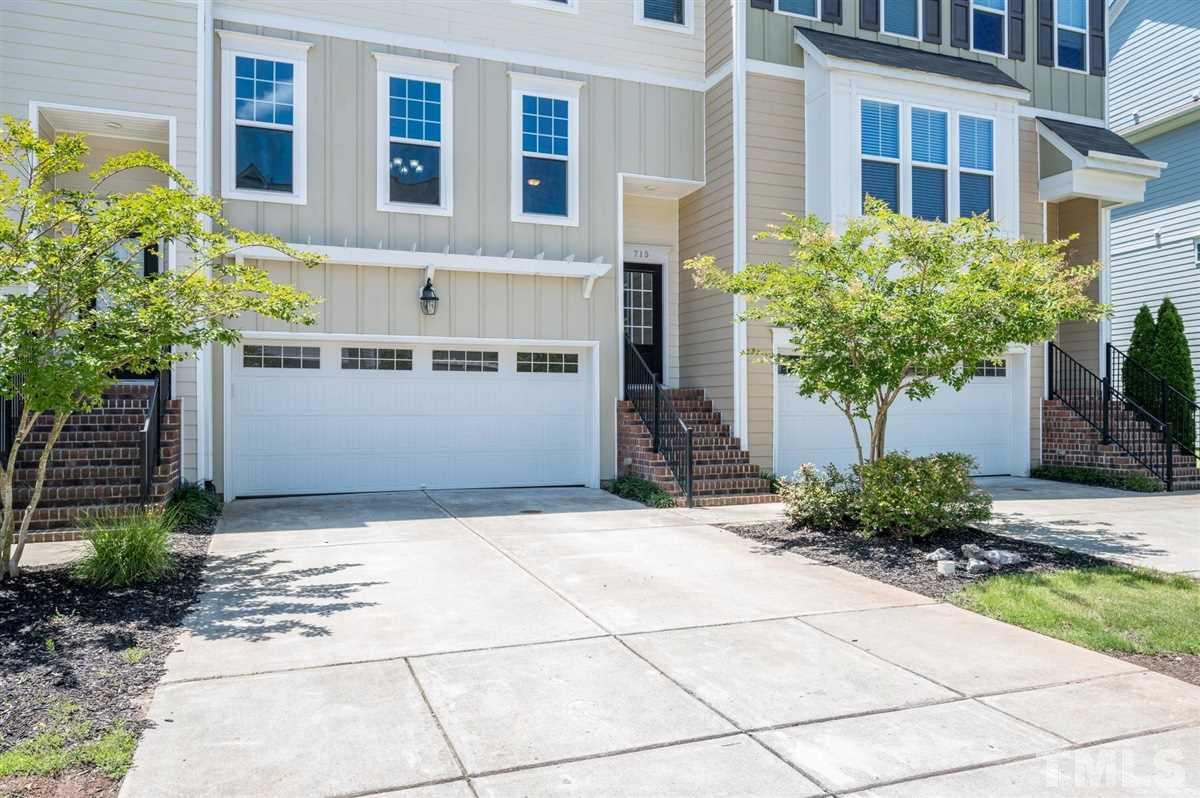 715 Edgewater Ridge Court Apex, NC 27523 - Photo 2 of 29 The two car garage offers enough space for vehicles, and a small side area for other storage needs.