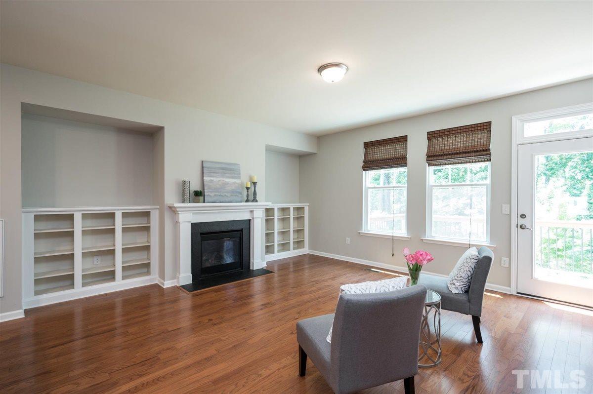 715 Edgewater Ridge Court Apex, NC 27523 - Photo 11 of 29 Family room with custom book cases.
