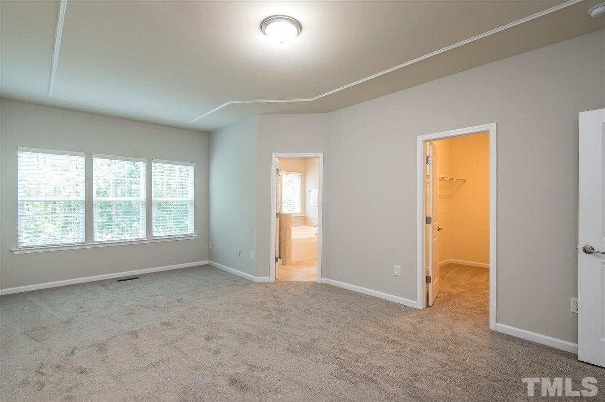 715 Edgewater Ridge Court Apex, NC 27523 - Photo 17 of 29 The master has its own bathroom and walk in closet.
