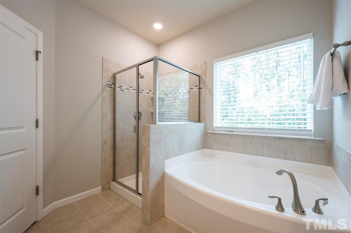715 Edgewater Ridge Court Apex, NC 27523 - Photo 20 of 29 Separate tub and shower for your convenience!