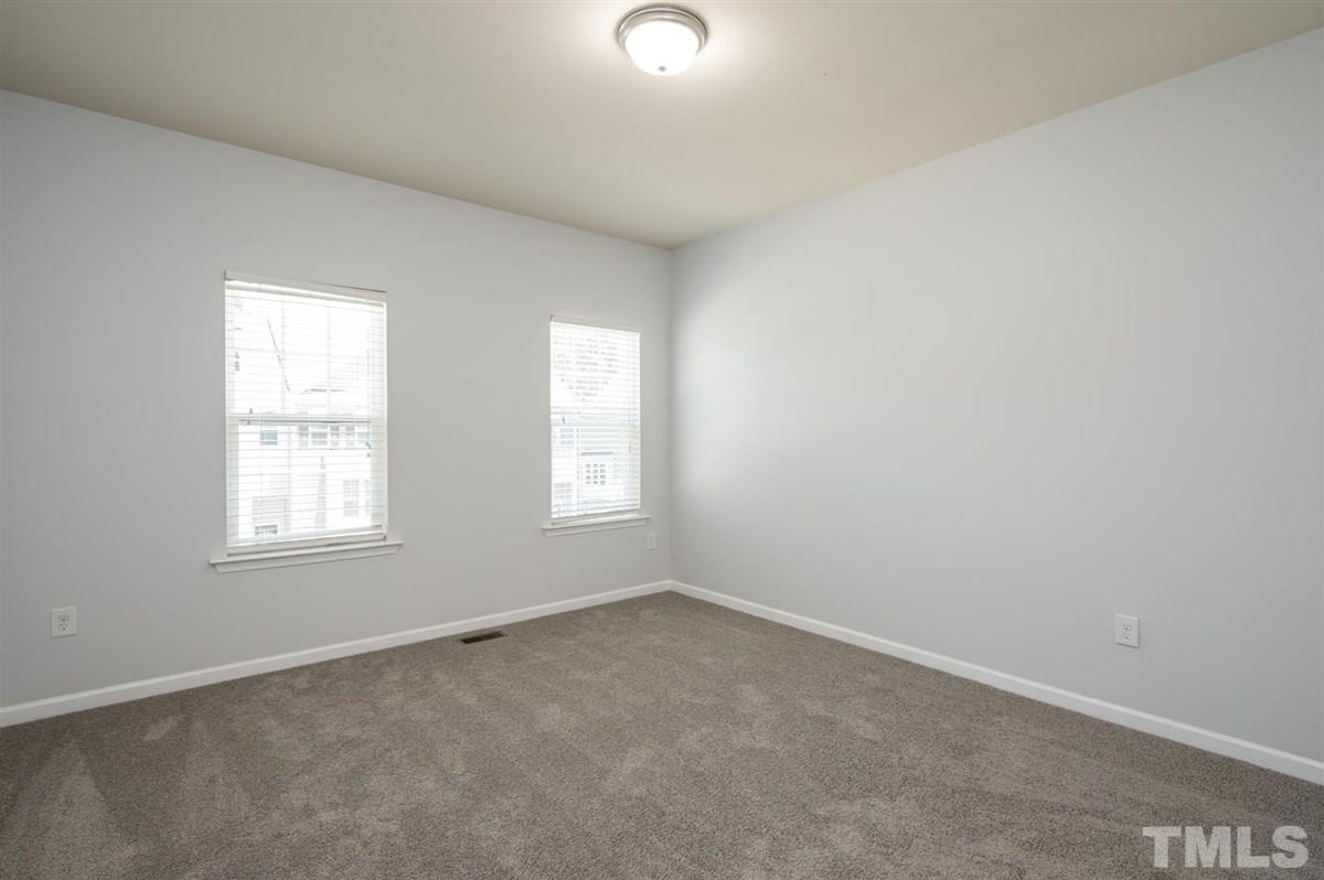 715 Edgewater Ridge Court Apex, NC 27523 - Photo 21 of 29 One of two secondary bedrooms on the 3rd floor.