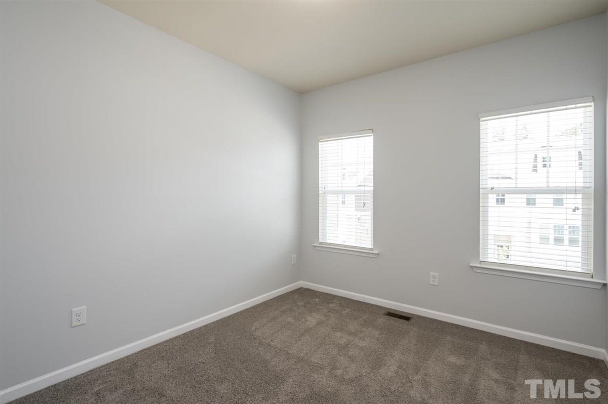 715 Edgewater Ridge Court Apex, NC 27523 - Photo 22 of 29 One of two secondary bedrooms on the 3rd floor.