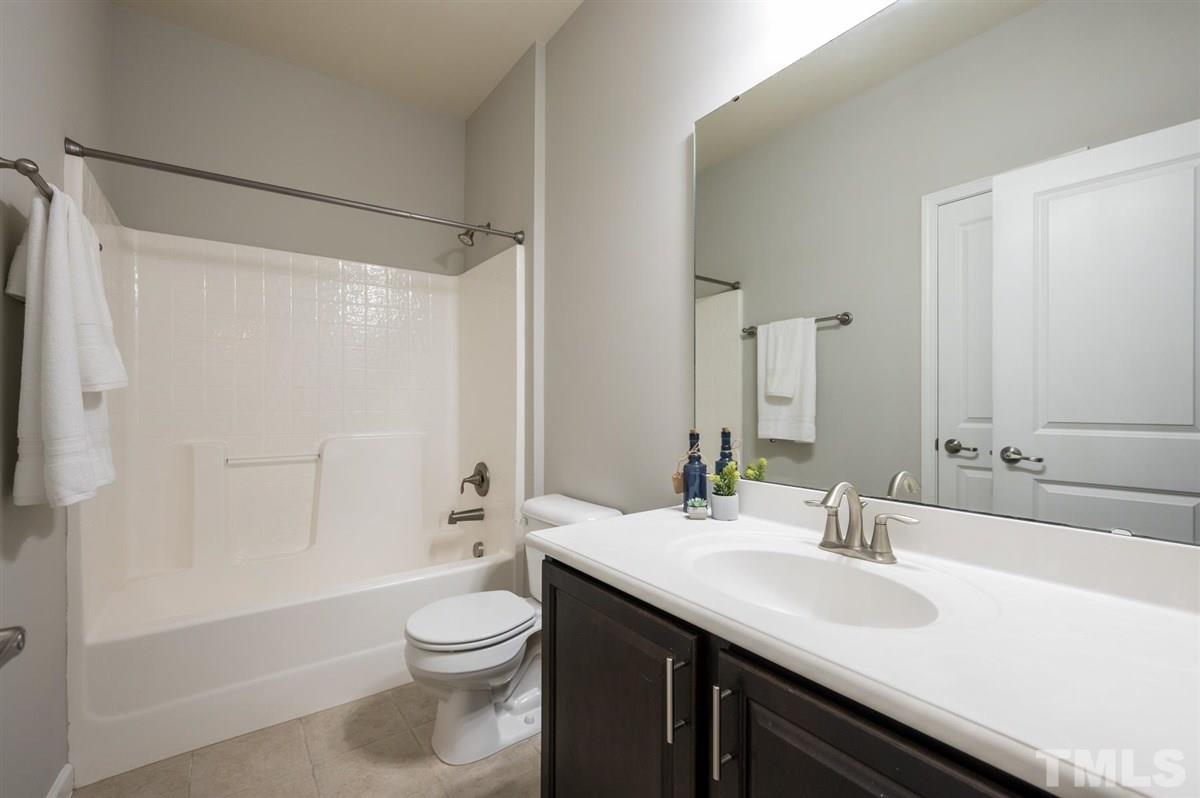 715 Edgewater Ridge Court Apex, NC 27523 - Photo 23 of 29 Hallway bathroom on the 3rd floor with linen closet.