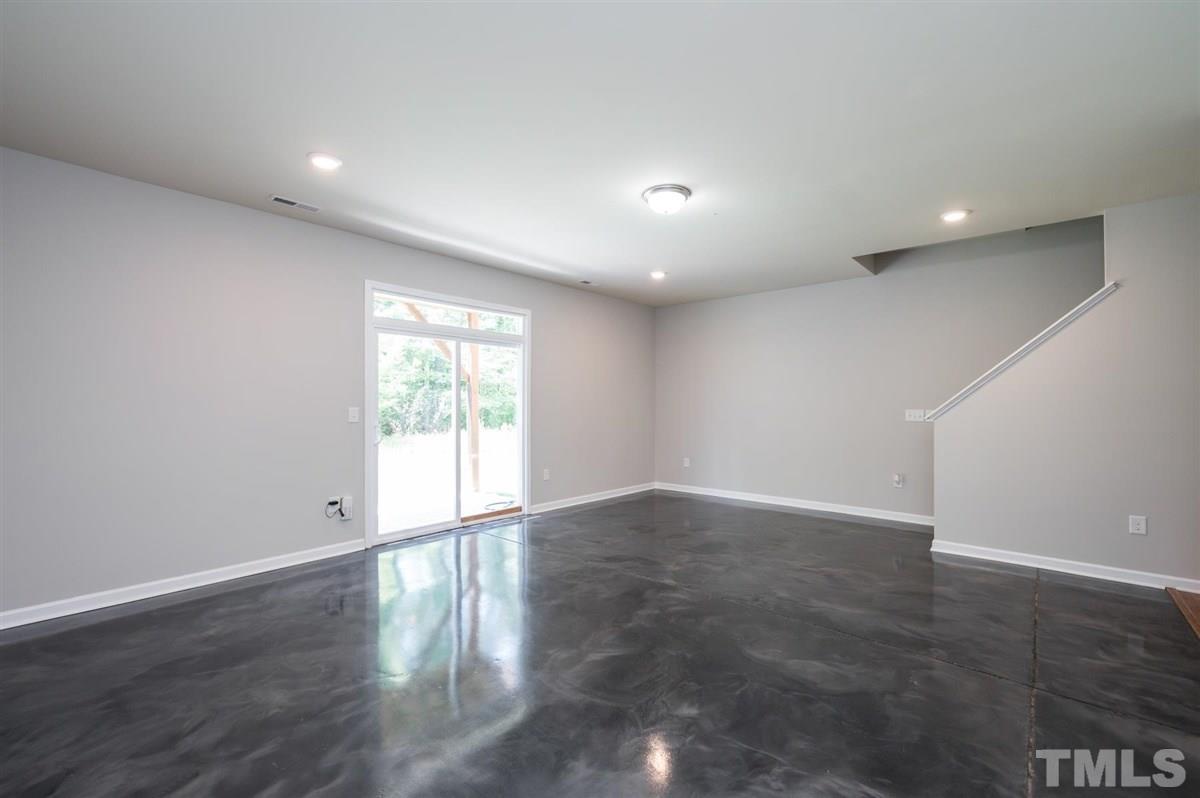 715 Edgewater Ridge Court Apex, NC 27523 - Photo 24 of 29 Bonus space at ground level. The options for this space are endless!