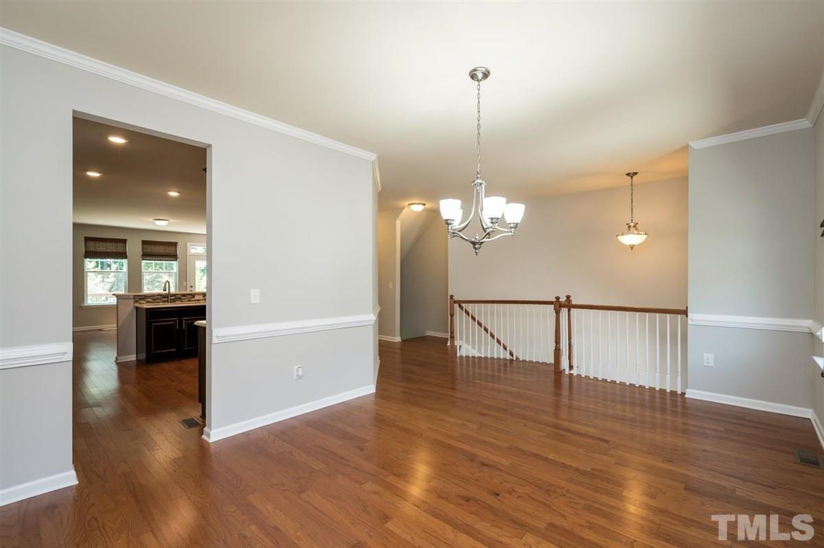715 Edgewater Ridge Court Apex, NC 27523 - Photo 5 of 29 The dining room offers plenty of light from the outside and a direct access to the kitchen.