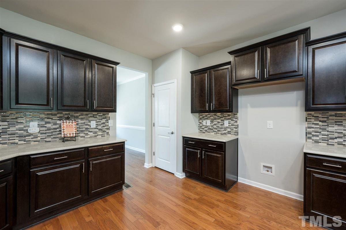 715 Edgewater Ridge Court Apex, NC 27523 - Photo 8 of 29 Convenient pantry for added storage.