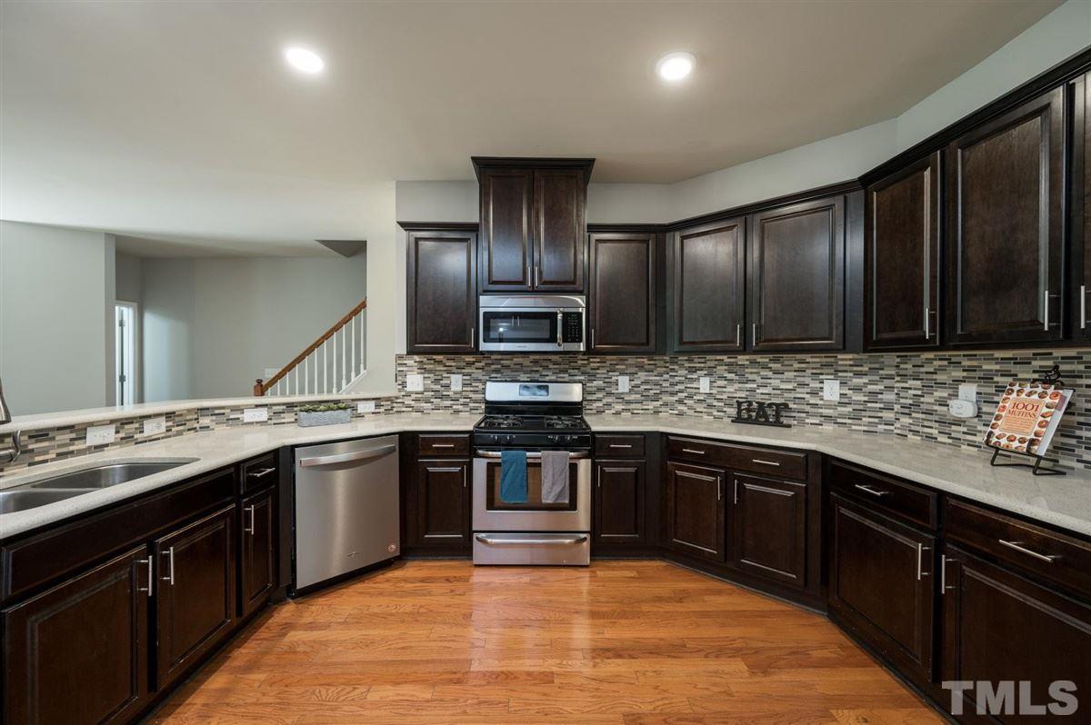 715 Edgewater Ridge Court Apex, NC 27523 - Photo 10 of 29 Granite counters, SS appliances, gas range, tile back splash. The list goes on and on.