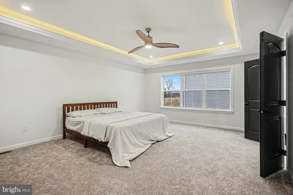 a spacious bedroom with a bed and a large window
