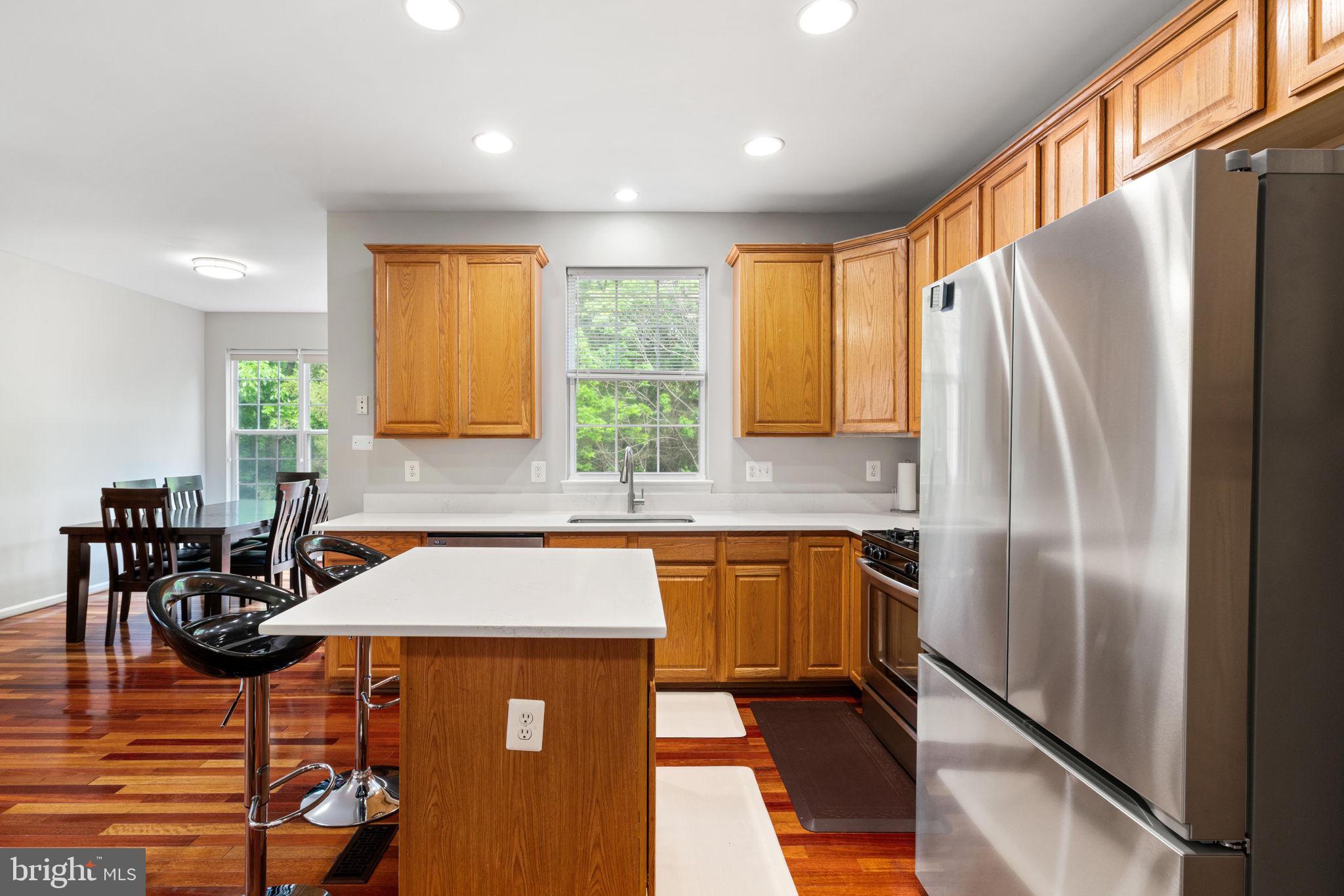 21654 Frame Square Broadlands, VA 20148 - Photo 12 of 43 Modern kitchen with warm wood accents.