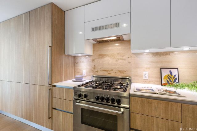 a kitchen with stainless steel appliances granite countertop a stove and a refrigerator