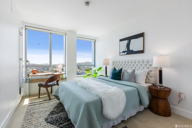 a bedroom with a bed and a night stand