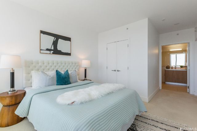 a bedroom with a bed and a lamp