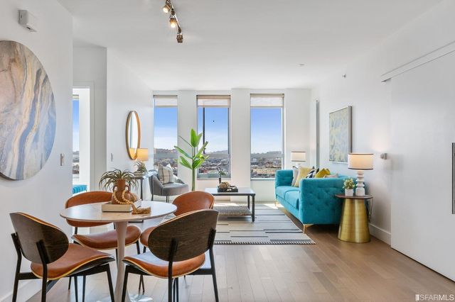 a dining room with furniture and wooden floor