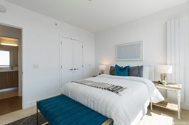 a bedroom with a bed and a mirror