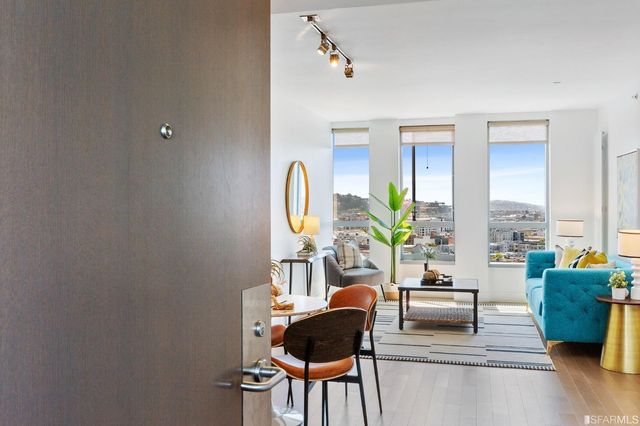 a living room with furniture and a potted plant