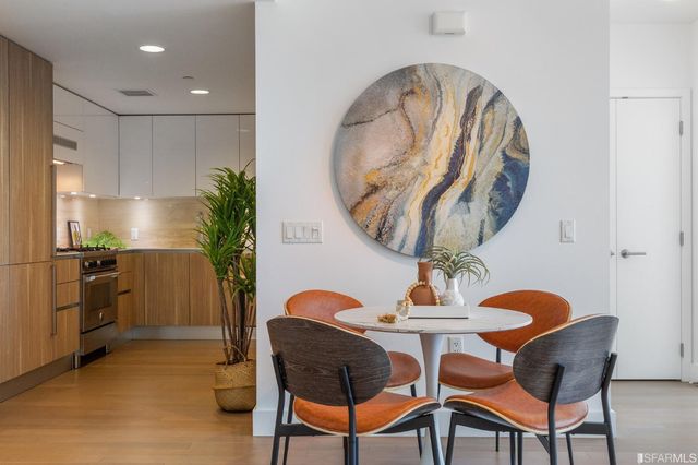 a dining room with furniture and wooden floor