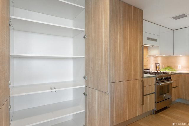 a kitchen with cabinets and a refrigerator