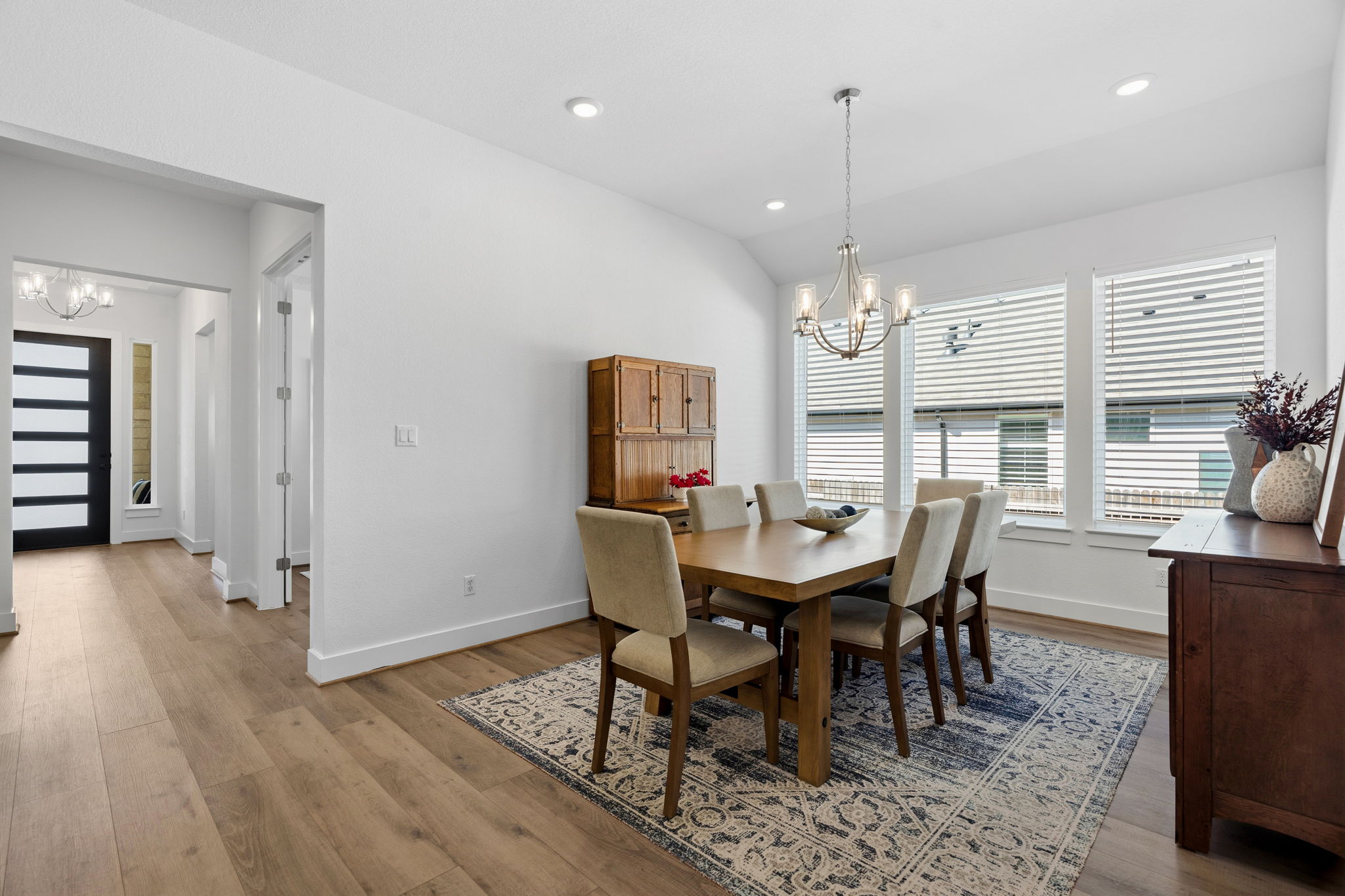 306 Bridge Water Loop Dripping Springs, TX 78620 - Photo 11 of 40 a view of a dining room with furniture window and wooden floor