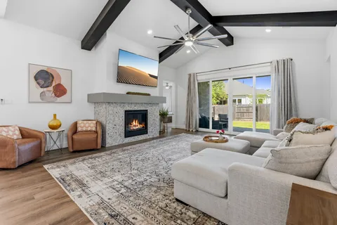 a living room with furniture and a wooden floor