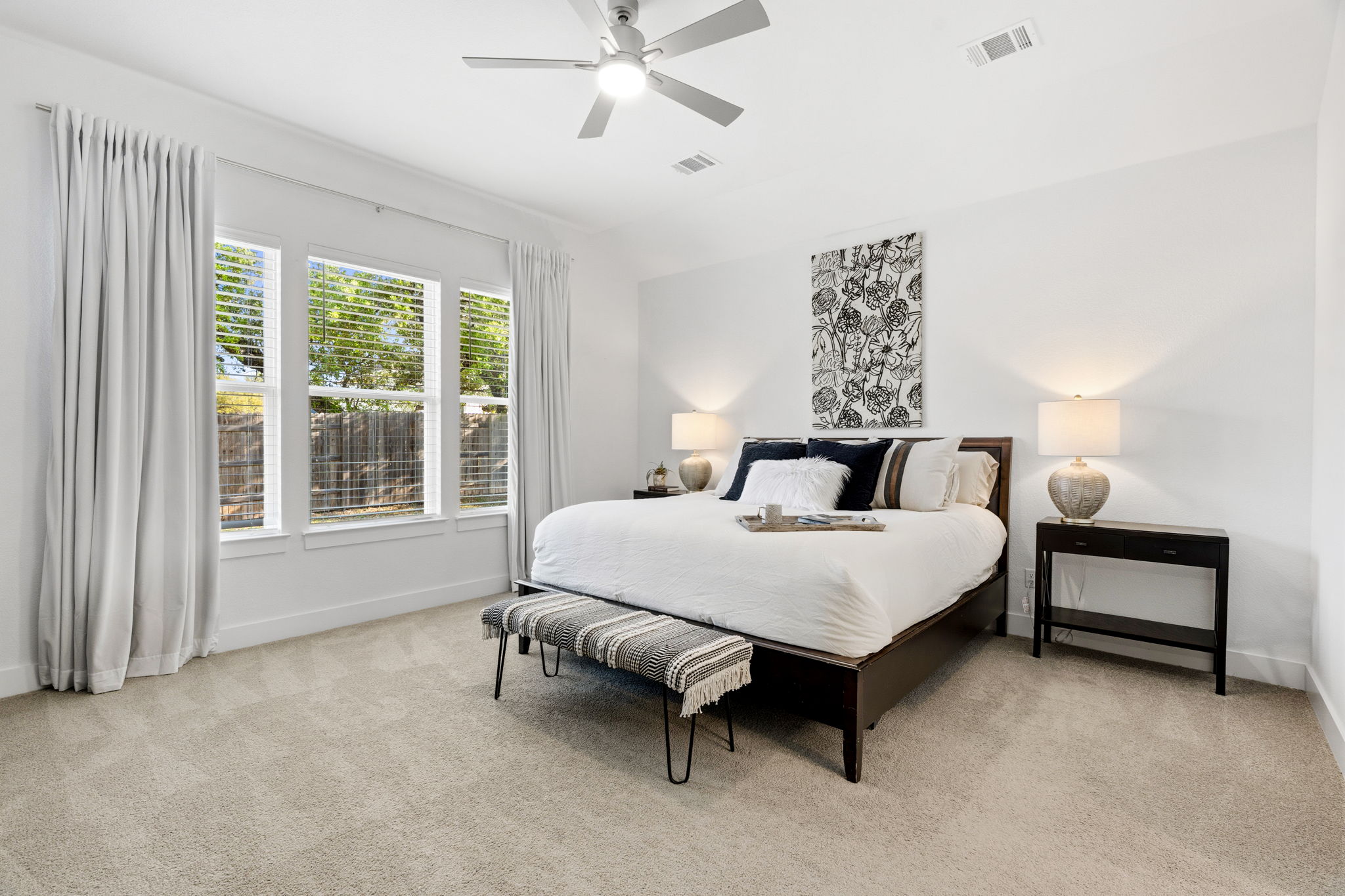 306 Bridge Water Loop Dripping Springs, TX 78620 - Photo 16 of 40 a bed room with a bed and a lamp