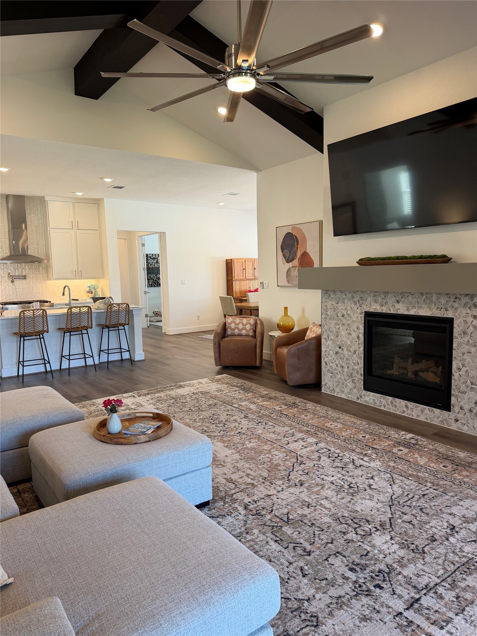 306 Bridge Water Loop Dripping Springs, TX 78620 - Photo 2 of 5 Living room featuring a glass covered fireplace, ceiling fan, dark wood-type flooring, and recessed lighting