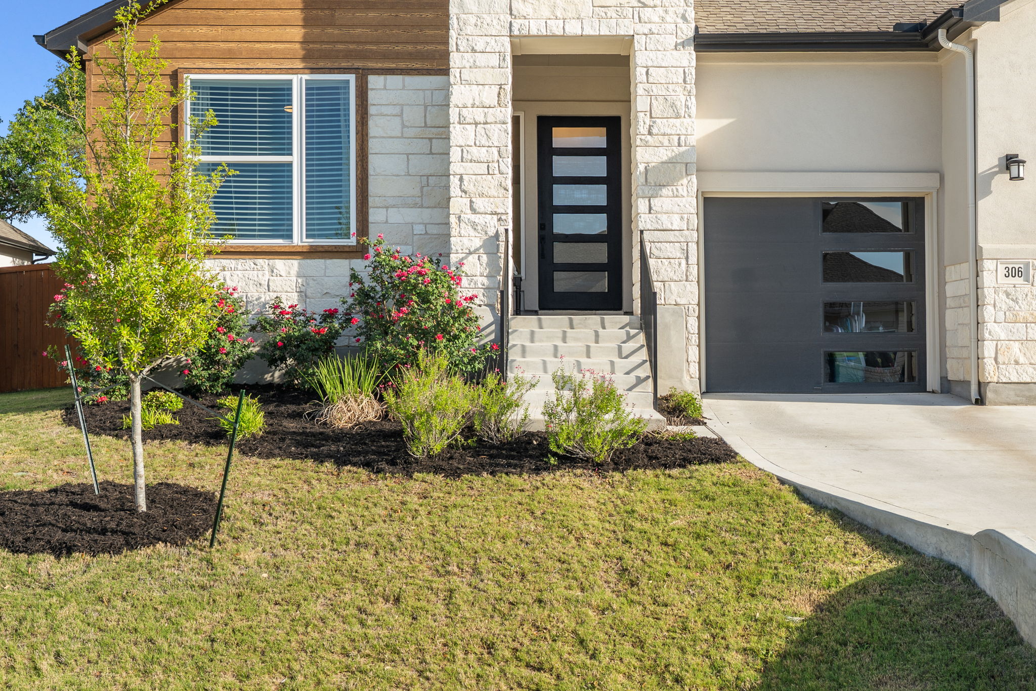 306 Bridge Water Loop Dripping Springs, TX 78620 - Photo 2 of 40 a front view of a house with a yard