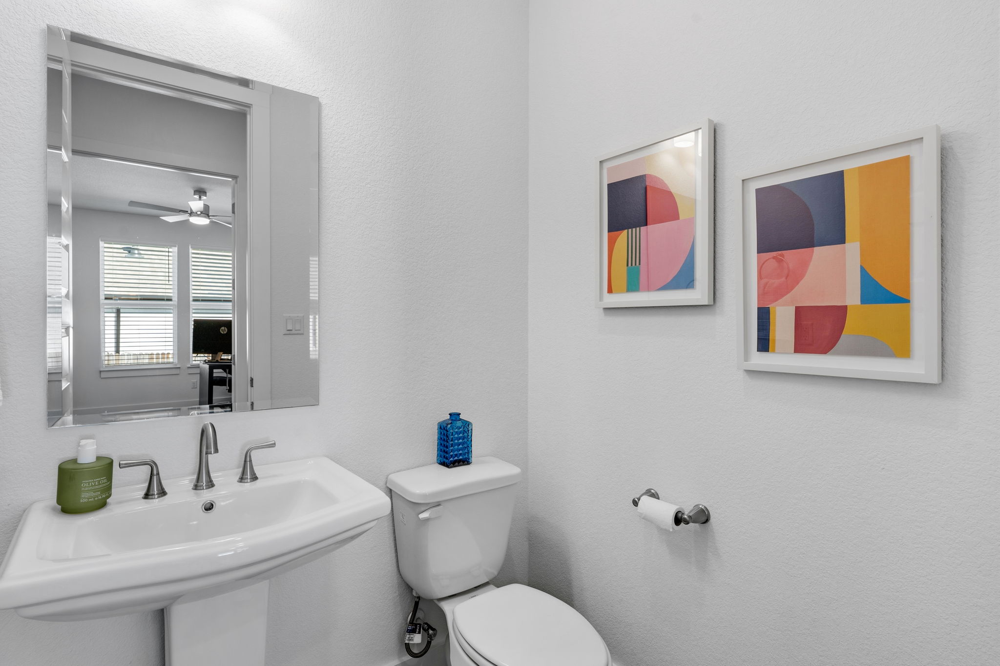 306 Bridge Water Loop Dripping Springs, TX 78620 - Photo 28 of 40 a bathroom with a toilet a sink and mirror