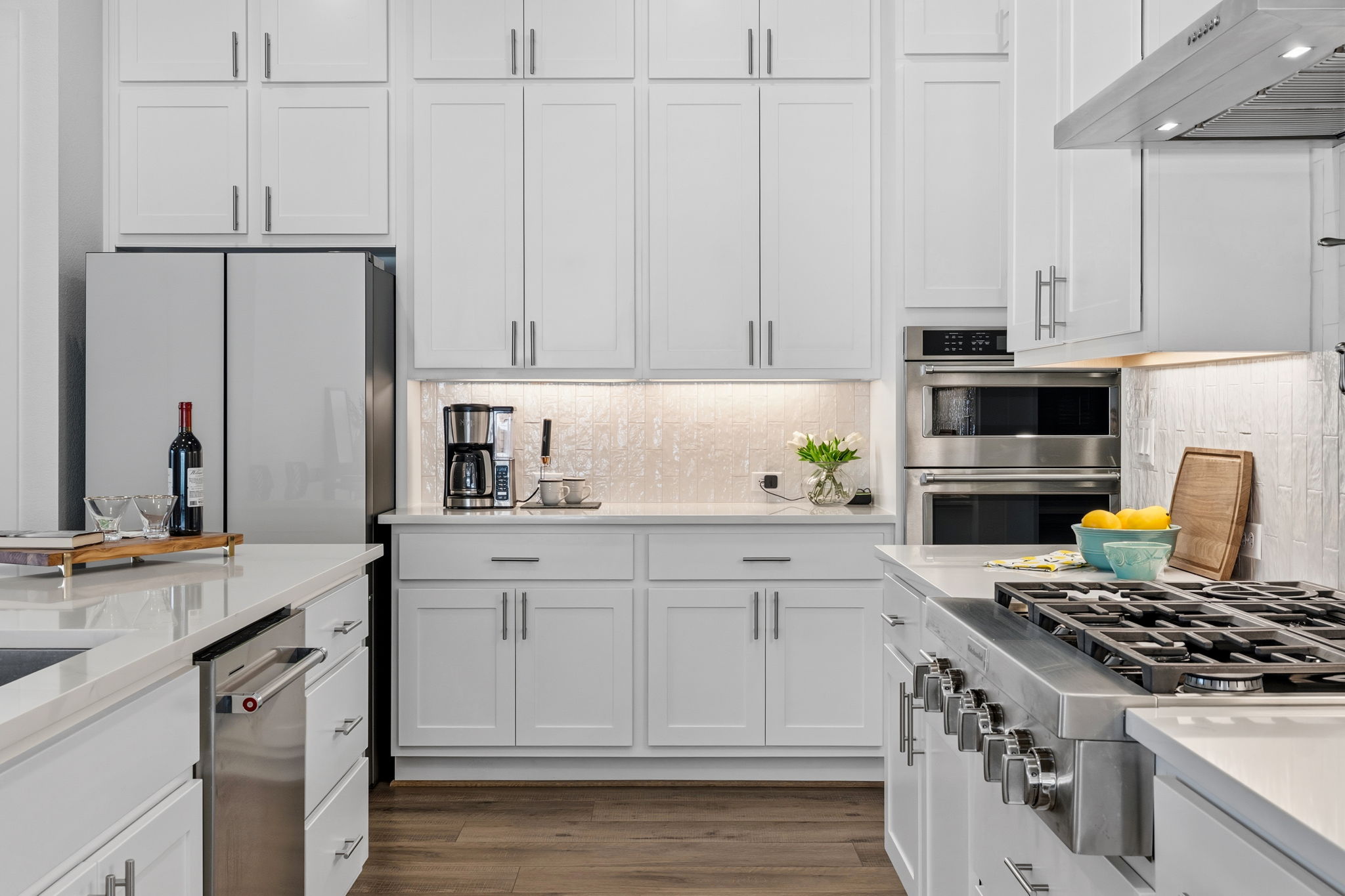 306 Bridge Water Loop Dripping Springs, TX 78620 - Photo 7 of 40 a kitchen with white cabinets and appliances