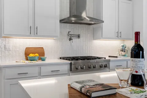 a kitchen with stainless steel appliances granite countertop a stove and a cabinets