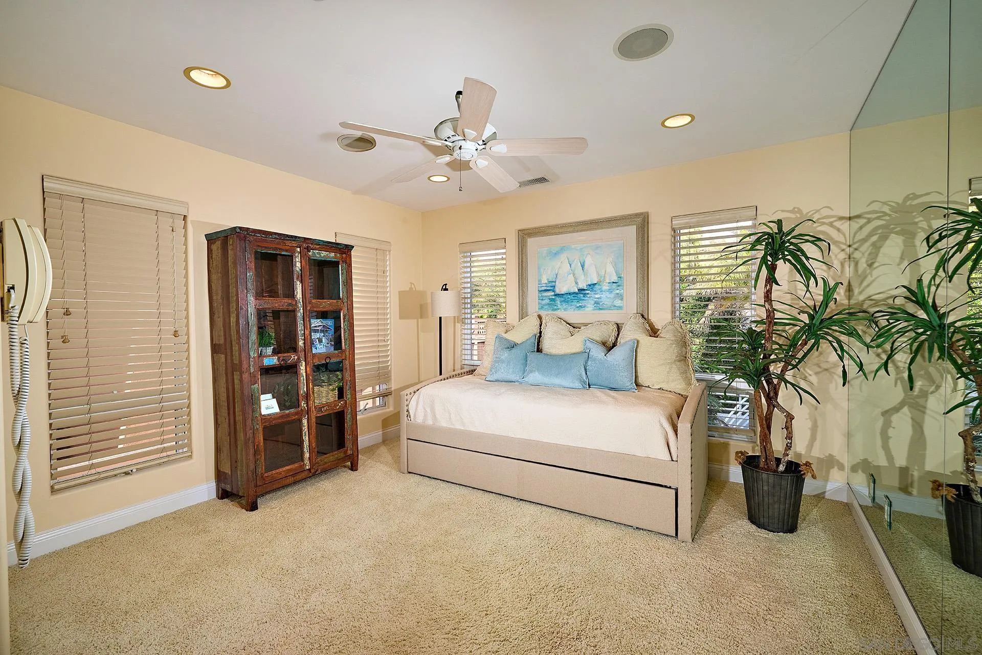 1630 Neptune Avenue Encinitas, CA 92024 - Photo 13 of 25 a bedroom with a bed and ceiling fan