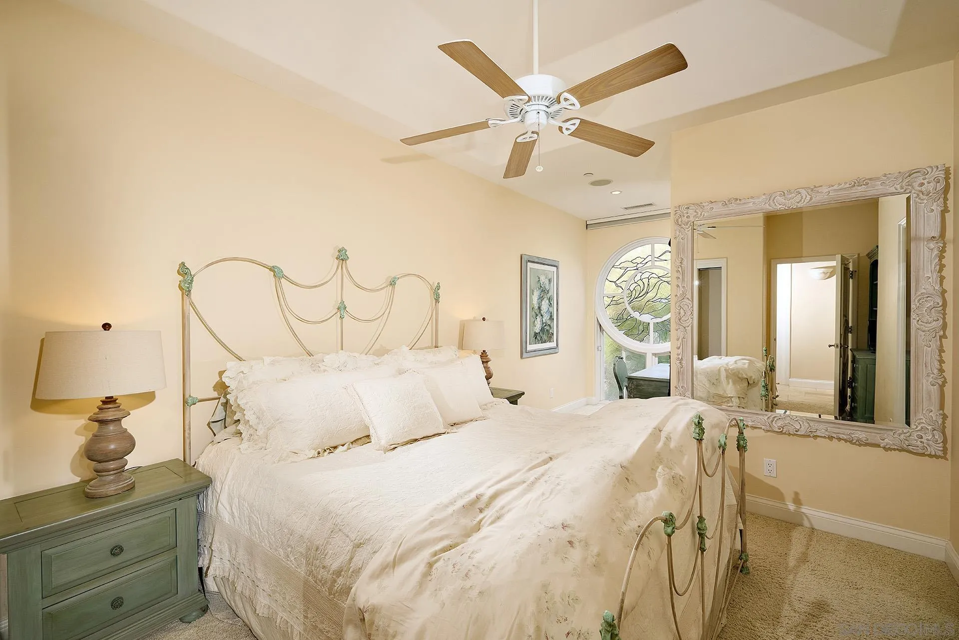 1630 Neptune Avenue Encinitas, CA 92024 - Photo 14 of 25 a bedroom with a bed and a chandelier