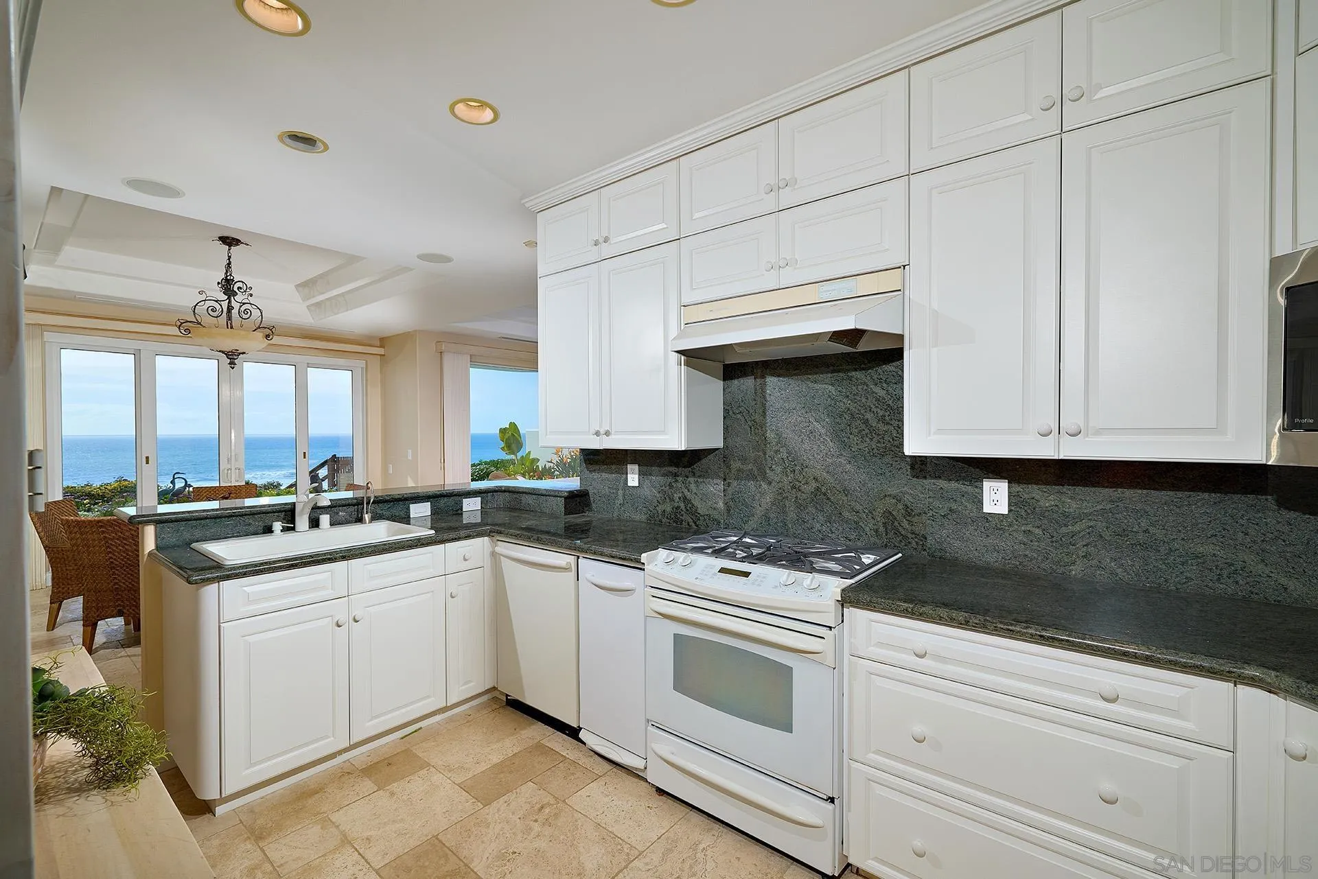 1630 Neptune Avenue Encinitas, CA 92024 - Photo 7 of 25 a kitchen with stainless steel appliances granite countertop a sink and cabinets