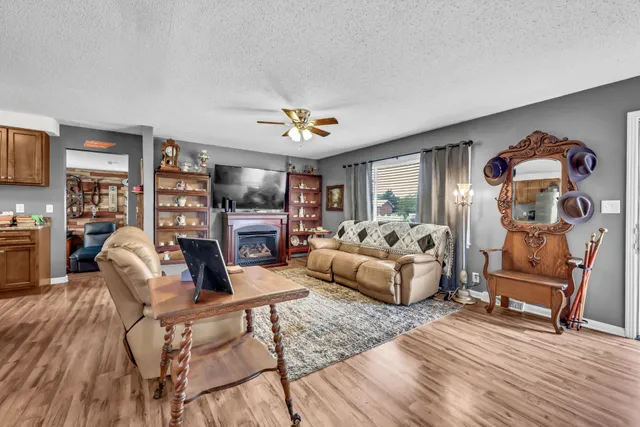 a living room with fireplace furniture and a wooden floor