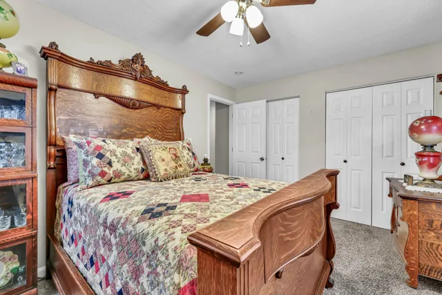 a bedroom with a bed and a chandelier