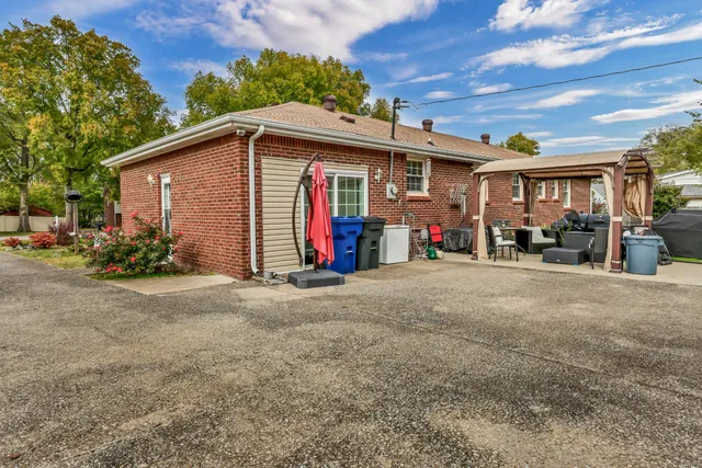 a front view of a house with a yard and parking
