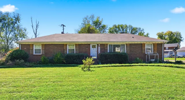 a front view of house with yard and green space