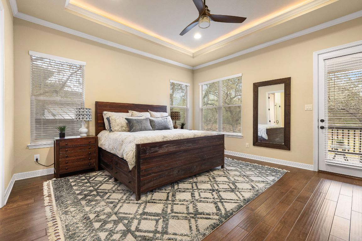103 Kendall Road Spicewood, TX 78669 - Photo 15 of 37 a bedroom with a large bed and a large window