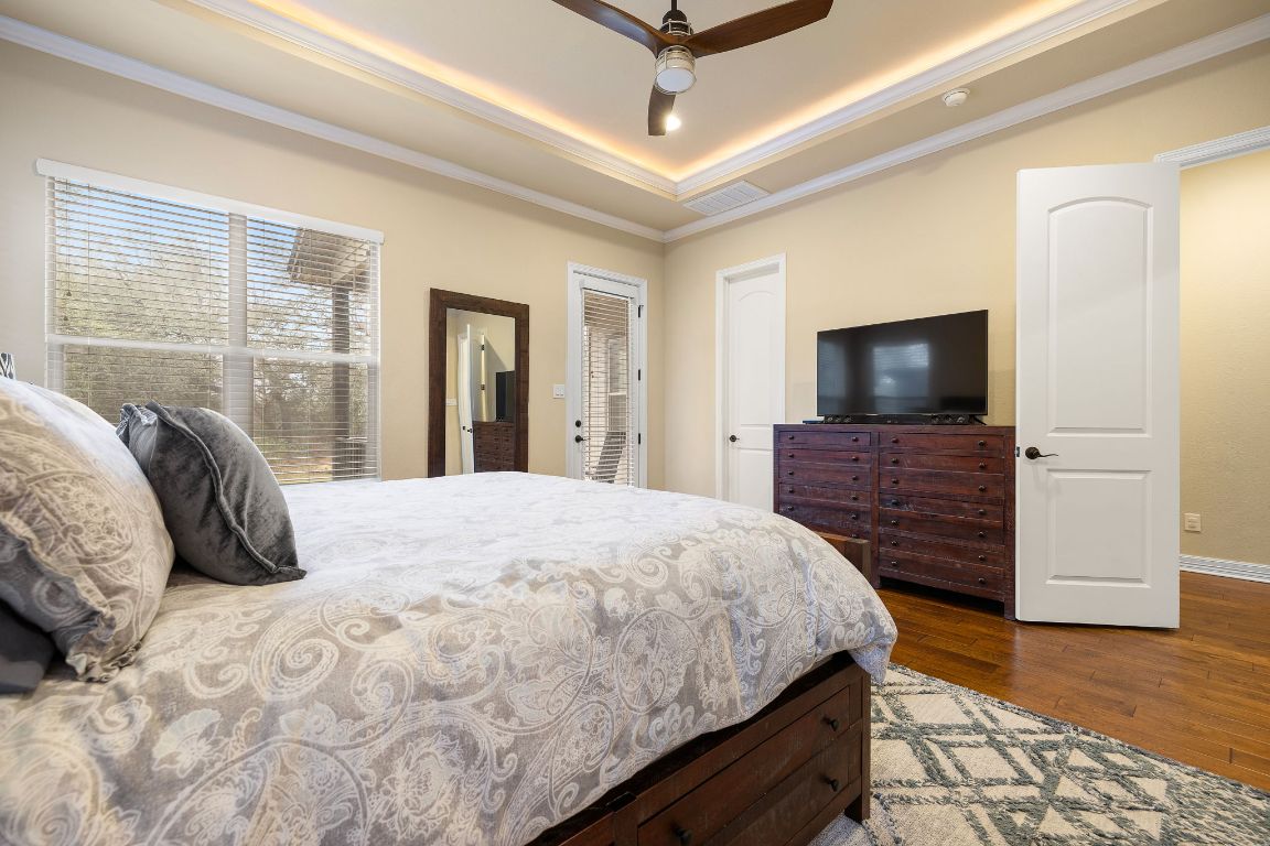 103 Kendall Road Spicewood, TX 78669 - Photo 16 of 37 a bedroom with a bed and a flat screen tv